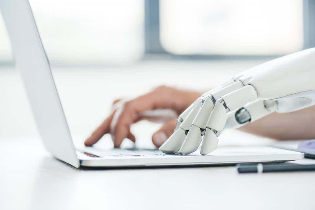 Robot hand and human hand illustrating ChatGPT and SEO in a CSP blog post.